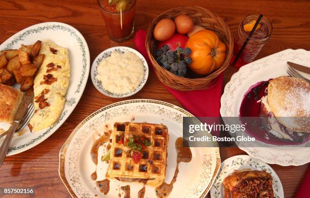 Clockwise from left: Farmhouse Omelet with buttermilk biscuit and home fries, Anson Mills Heirloom Grits, Bloody Mary, Campari soda, Victoria...