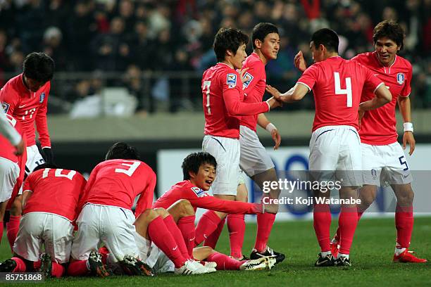 Ji-Sung Park , Won-hee Cho and Dong-jin Kim of South Korea celebrate with team mates after the first goal during the 2010 FIFA World Cup Asian...