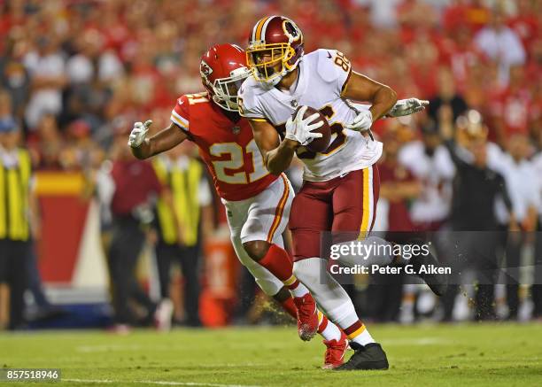 Tight end Jordan Reed of the Washington Redskins runs down field against defensive back Eric Murray of the Kansas City Chiefs during the first half...