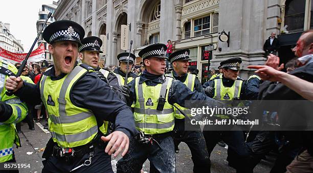 Police react to protesters as they block access to a branch of RBS stopping anti capitalist and climate change activists demonstrating in the City of...