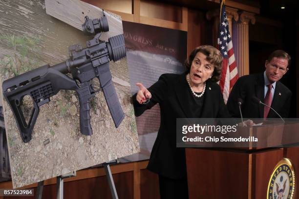 Sen. Dianne Feinstein and Sen. Richard Blumenthal points to a photograph of a rifle with a "bump stock" during a news conference to announce proposed...