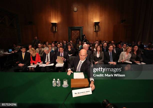 Former Equifax CEO Richard Smith prepares to testify before the Senate Banking, Housing and Urban Affairs Committee in the Hart Senate Office...