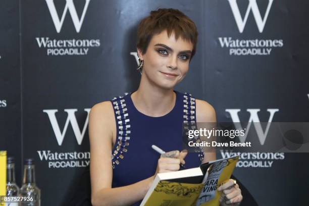 Cara Delevingne signs copies of her new book "Mirror, Mirror" at Waterstones Piccadilly on October 4, 2017 in London, England.