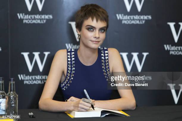 Cara Delevingne signs copies of her new book "Mirror, Mirror" at Waterstones Piccadilly on October 4, 2017 in London, England.