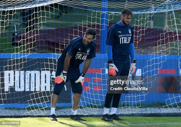 Gianluigi Buffon and Gianluigi Donnarumma of Italy look on during a training session at Italy club's training ground at Coverciano on October 4, 2017...