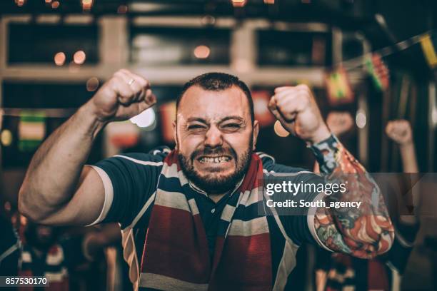 excited man watching a game - tv audience stock pictures, royalty-free photos & images