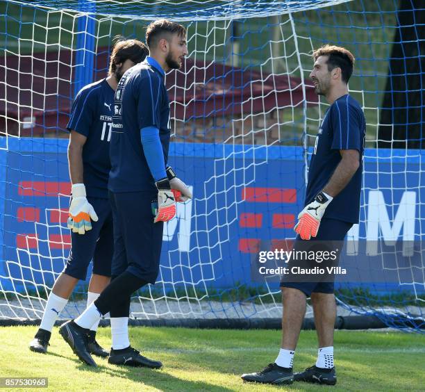 Gianluigi Buffon and Gianluigi Donnarumma of Italy chat during a training session at Italy club's training ground at Coverciano on October 4, 2017 in...