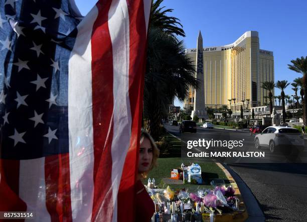 The US flag is left at a makeshift memorial outside the Route 91 music festival site beside the Mandalay Hotel October 4, 2017 on the Las Vegas...