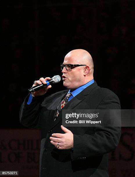 Tenor Ronan Tynan sings "God Bless America" prior to a game between the Buffalo Sabres and the Florida Panthers on March 25, 2009 at HSBC Arena in...