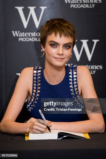 Cara Delevingne attends the signing of her debut Young Adult novel 'Mirror, Mirror' at Waterstones Piccadilly on October 4, 2017 in London, England.