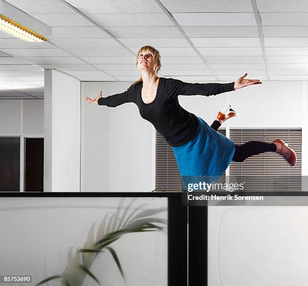 woman floating in an office. - levitation stock pictures, royalty-free photos & images