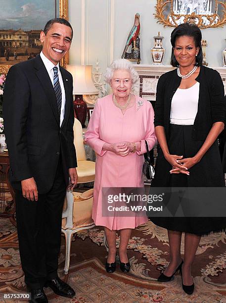 President Barack Obama and his wife Michelle Obama pose for photographs with Queen Elizabeth II during an audience at Buckingham Palace on April 1,...