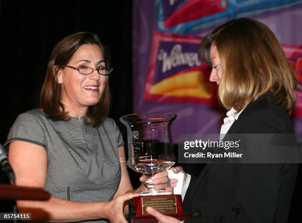 Moderator and ECM President, NAC Maria Angles presents award to CEO of Cinema Solutions, Anita Watts recipient of "The Bert Nathan Memorial Award" at...