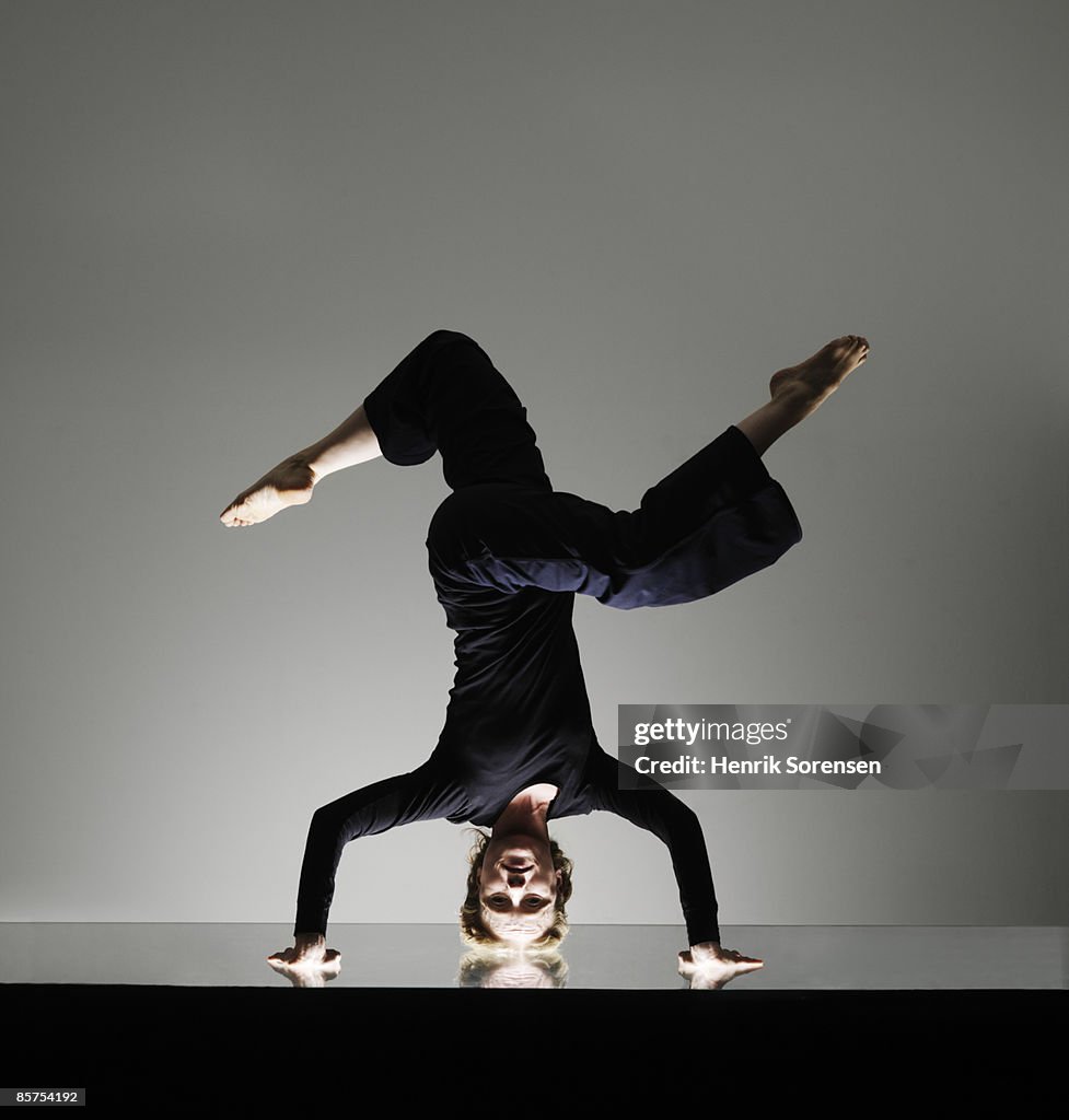 Woman doing a yoga headstand.