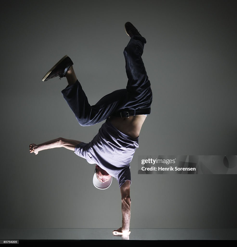 Man doing a handstand on one hand