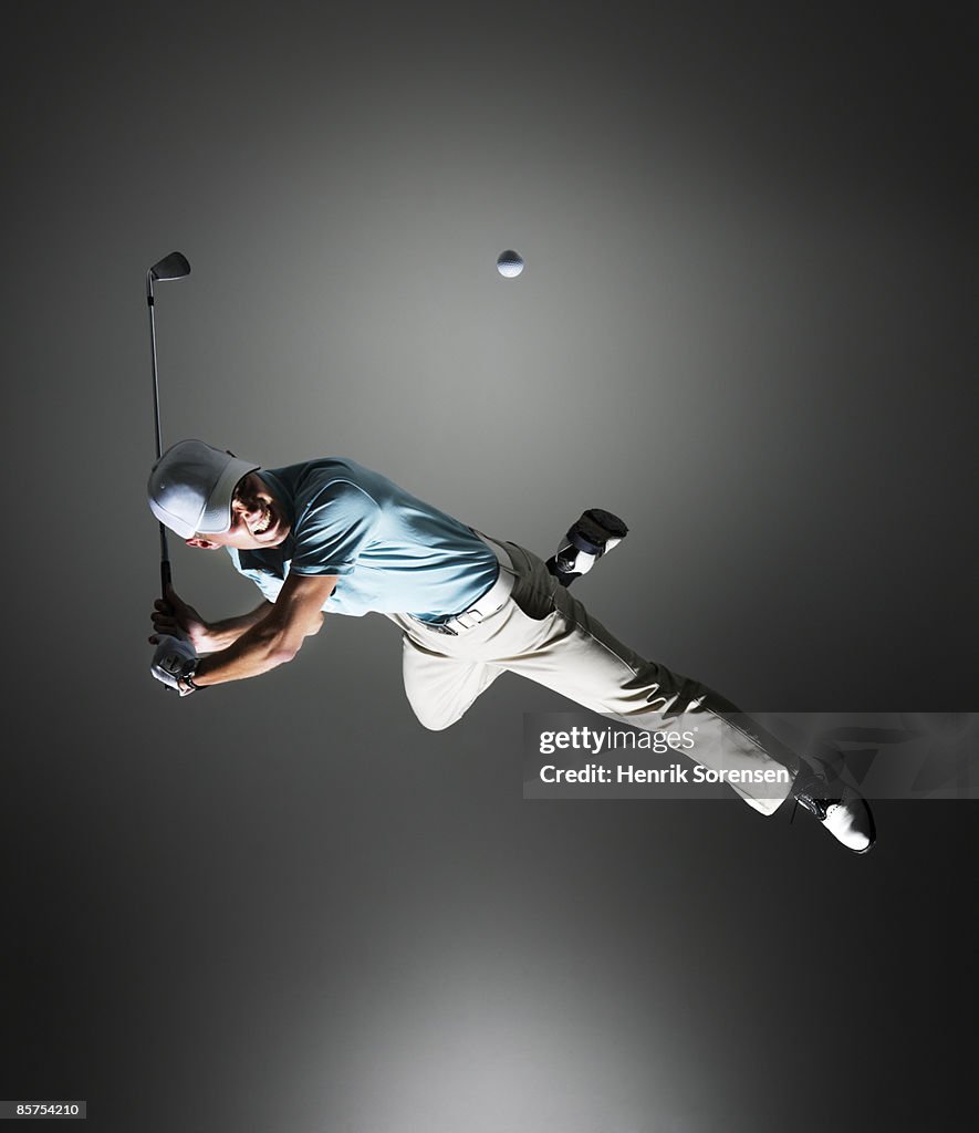 Golf player hanging in the air.