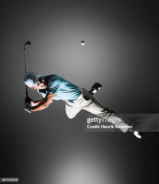 golf player hanging in the air. - indoor golf stock pictures, royalty-free photos & images