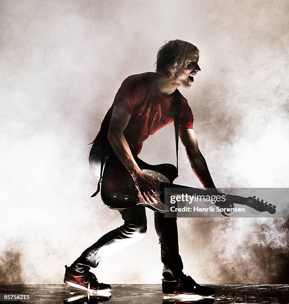 rock star with his guitar. - rock musician stock pictures, royalty-free photos & images