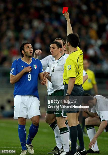 Giampaolo Pazzini of Italy is shown a red card by referee Wolfgang Stark after an elbow to the head of John O'Shea of Ireland during the FIFA 2010...