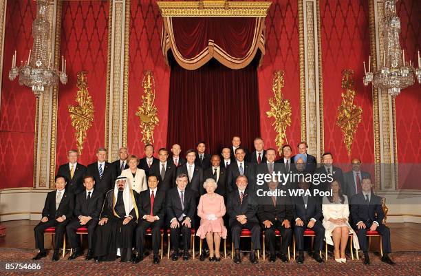 Queen Elizabeth II poses with delegates of the G20 London summit for a group photograph in the Throne Room at Buckingham Palace on April 1, 2009 in...