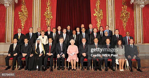 Queen Elizabeth II poses with delegates of the G20 London summit for a group photograph in the Throne Room at Buckingham Palace on April 1, 2009 in...