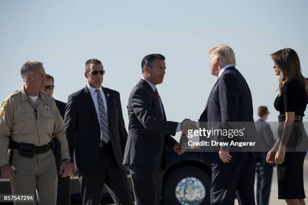 Clark County Sheriff Joe Lombardo and first lady Melania Trump look on as Nevada Governor Brian Sandoval shakes hands with President Donald Trump...