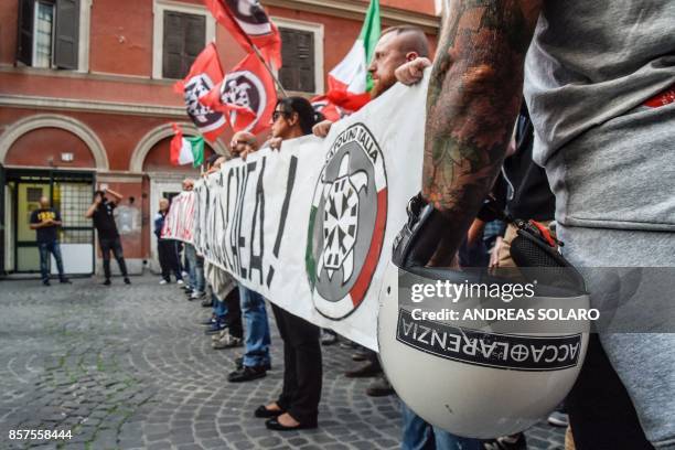 Supporters of Italian far-right movement CasaPound hold a banner reading "Enough deterioration, Close the Mosque" during a protest against a mosque...