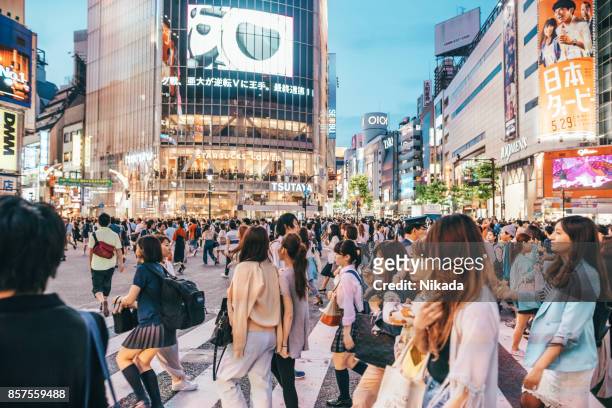 famous shibuya crossing in tokyo, japan - mass consumerism stock pictures, royalty-free photos & images