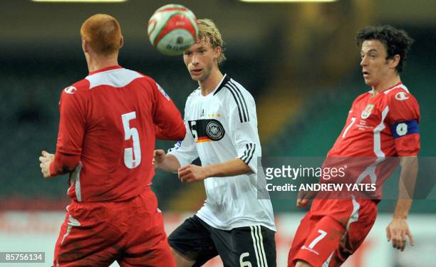 Germany's midfielder Simon Rolfes vies with Wales' midfielder James Collins and Wales' midfielder Simon Davies during the FIFA World Cup 2010...