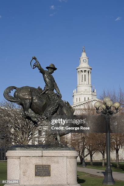 Bronze sculpture of a "bronco busting" cowboy, located in Civic Center Park near the City Hall building, is seen in this 2009 Denver, Colorado,...