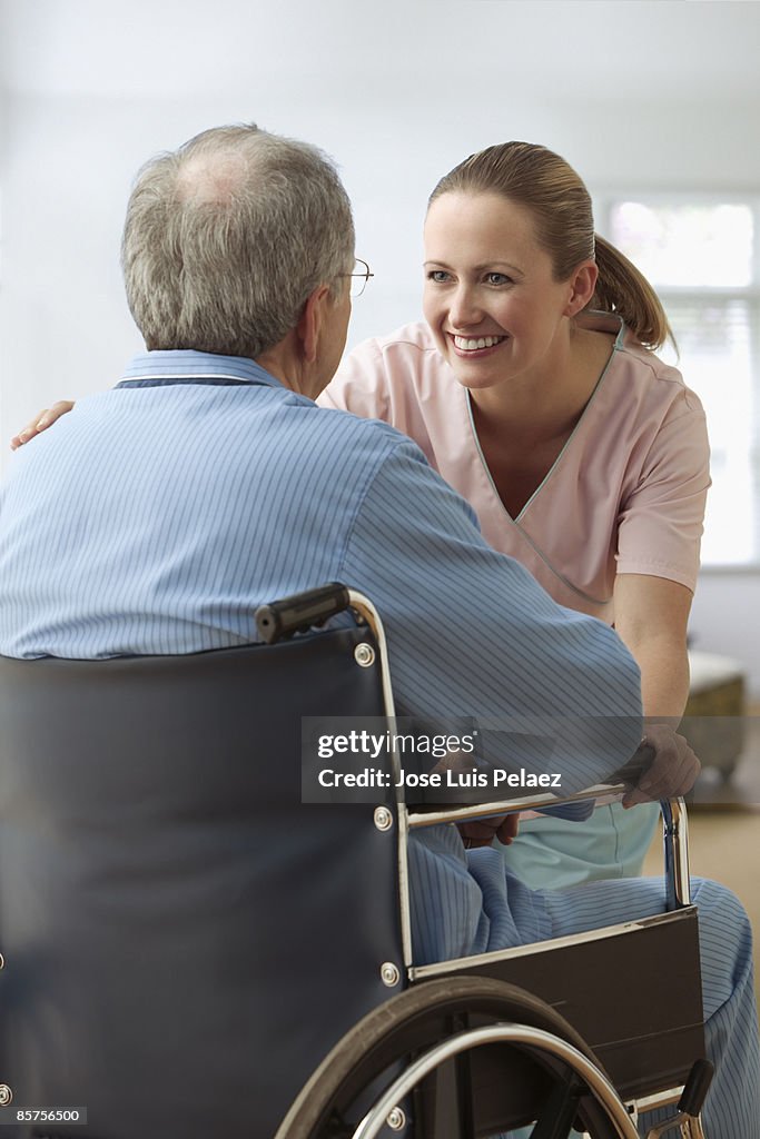 Female nurse smiling at male patient