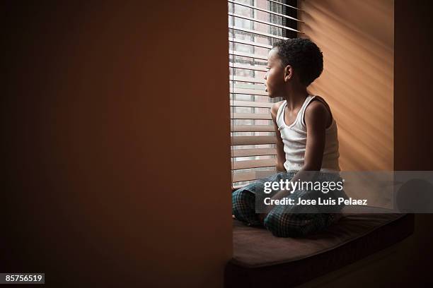 little boy looking out the window - waiting anticipation stock pictures, royalty-free photos & images