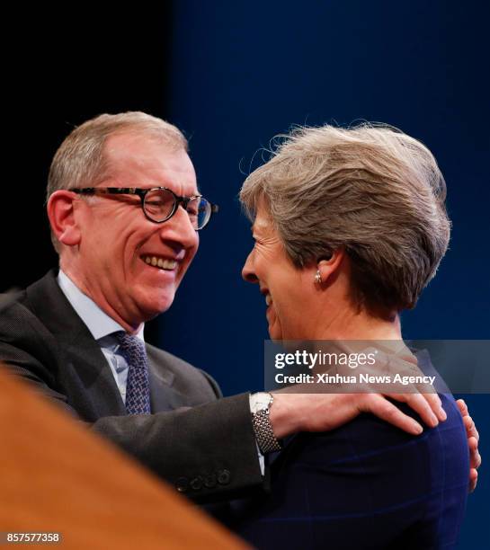 Oct. 4, 2017 -- Britain's Prime Minister Theresa May is embraced by husband Philip after delivering her keynote speech on the last day of the...