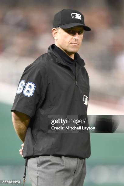 Umpire Chris Guccione looks on during a baseball game between the Pittsburgh Pirates and the Washington Nationals at Nationals Park on September 28,...