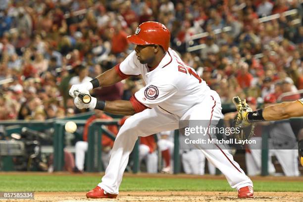 Alejandro De Aza of the Washington Nationals bunts during a baseball game against the Pittsburgh Pirates at Nationals Park on September 28, 2017 in...