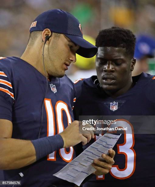 Mitchell Trubisky of the Chicago Bears goes over a play with Kendall Wright during a game against the Green Bay Packers at Lambeau Field on September...