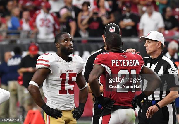 Patrick Peterson of the Arizona Cardinals and Pierre Garcon of the San Francisco 49ers meet at midfield at the start of overtime for the coin flip by...