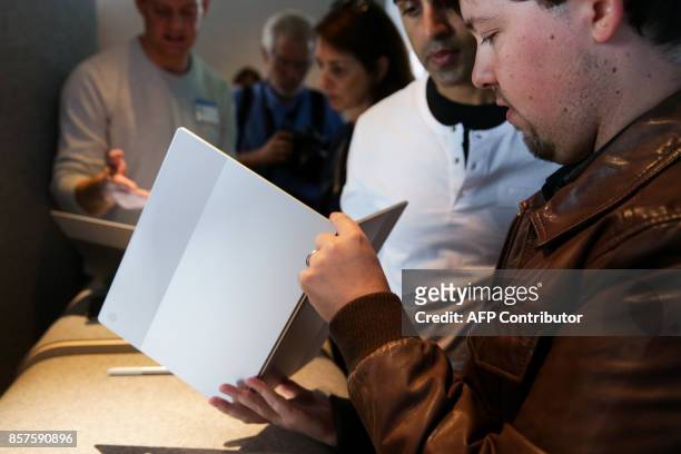 Members of the media examine the new Pixelbook laptop at a product launch event on October 4, 2017 at the SFJAZZ Center in San Francisco, California....