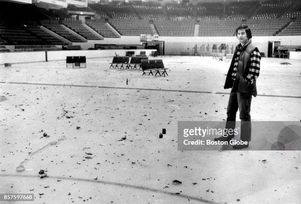 Weston Adams, owner of the Boston Garden, looks at debris thrown onto ice after a crowd waiting in line to purchase advance tickets to a Led Zeppelin...