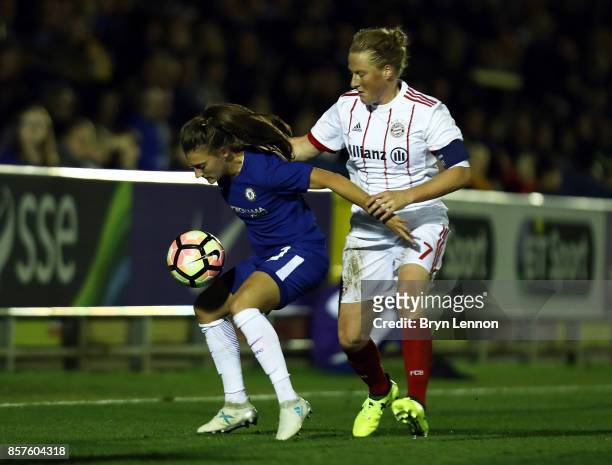 Hannah Blundell of Chelsea Ladies is tackled by Melanie Behringer of Bayern Munich during the UEFA Womens Champions League Round of 32: First Leg...