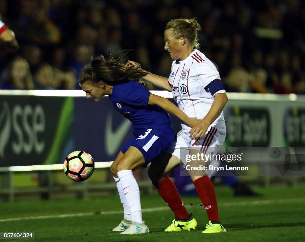 Hannah Blundell of Chelsea Ladies is tackled by Melanie Behringer of Bayern Munich during the UEFA Womens Champions League Round of 32: First Leg...