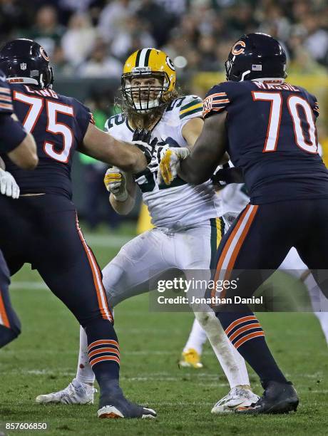 Clay Matthews of the Green Bay Packers rushes against Kyle Long and Bobby Massie of the Chicago Bears at Lambeau Field on September 28, 2017 in Green...