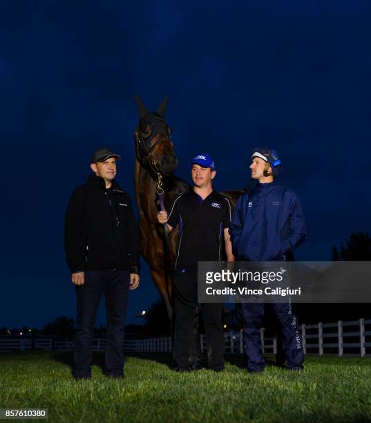 Trainer Chris Waller, Jockey Hugh Bowman and strapper Umut Odemislioglu pose with Winx after a Trackwork Session at Flemington Racecourse on October...