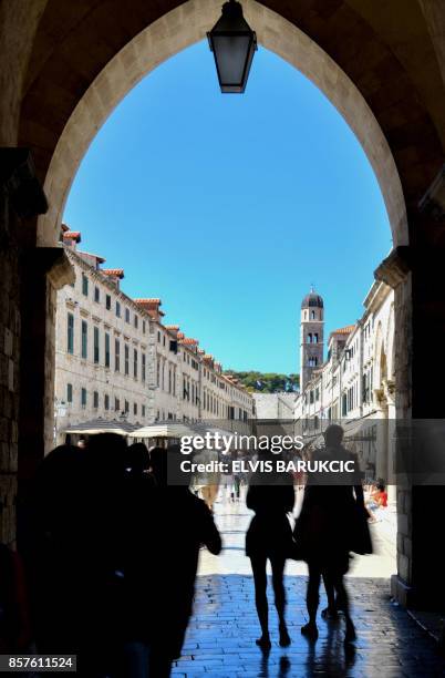 Picture taken on September 25 shows tourists walking in Dubrovnik, southern Croatia. Local traffic as well as tourists traveling between Northern and...