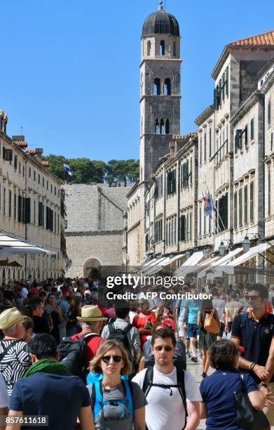 Picture taken on September 25 shows tourists walking in Dubrovnik, southern Croatia. Local traffic as well as tourists traveling between Northern and...