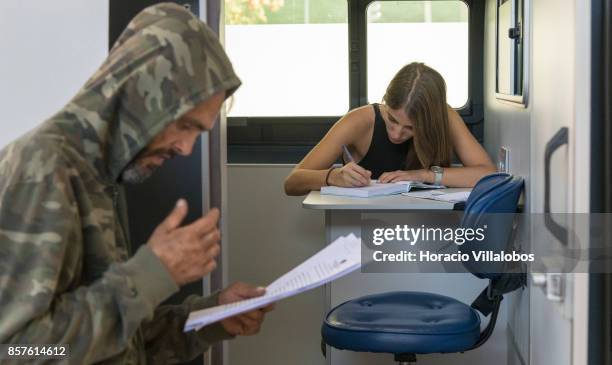 New patient waits outside a van parked near Praca Espanha to be interviewed by a member of the staff before receiving his first daily dose of 85...