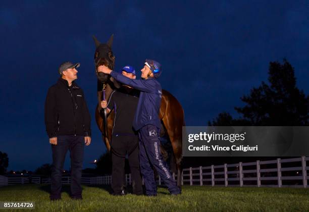 Trainer Chris Waller, Jockey Hugh Bowman and strapper Umut Odemislioglu pose with Winx after a Trackwork Session at Flemington Racecourse on October...