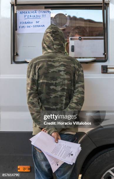 New patient waits outside a van parked near Praca Espanha to receive from male nurse Joao Matos his daily dose of 85 milligrams of methadone on...