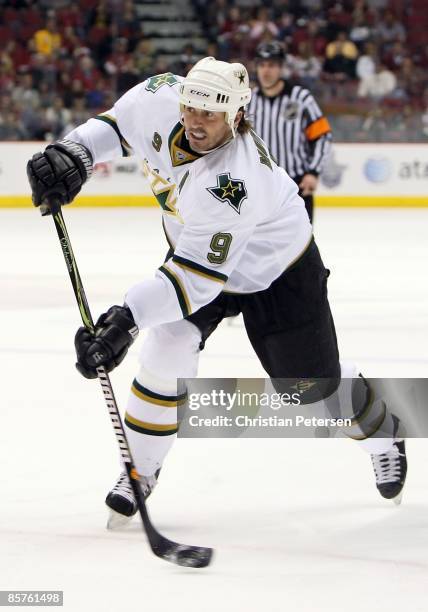 Mike Modano of the Dallas Stars shoots the puck during the NHL game against the Phoenix Coyotes at Jobing.com Arena on March 30, 2009 in Glendale,...