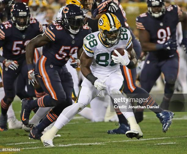 Ty Montgomery of the Green Bay Packers runs past Danny Trevathan of the Chicago Bears at Lambeau Field on September 28, 2017 in Green Bay, Wisconsin....